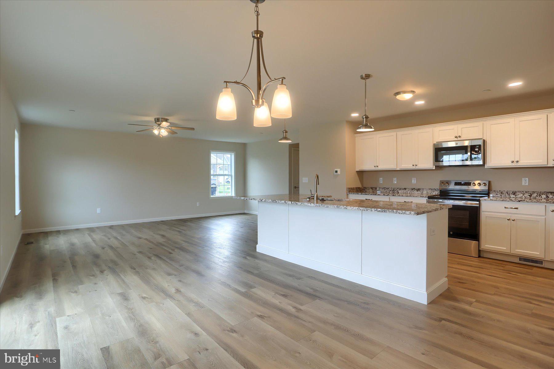 75 Cortland Crossing Palmyra, PA 17078 - Photo 7 of 21 a kitchen with stainless steel appliances granite countertop a refrigerator a stove top oven a sink dishwasher and white cabinets with wooden floor