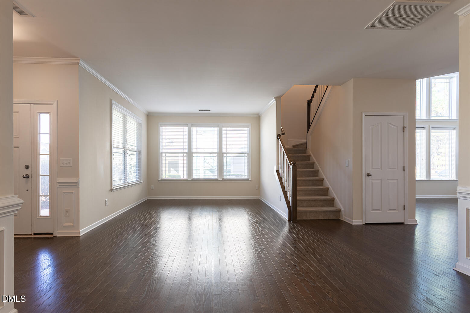 209 Mayfield Drive Apex, NC 27539 - Photo 11 of 48 an empty room with wooden floor and windows