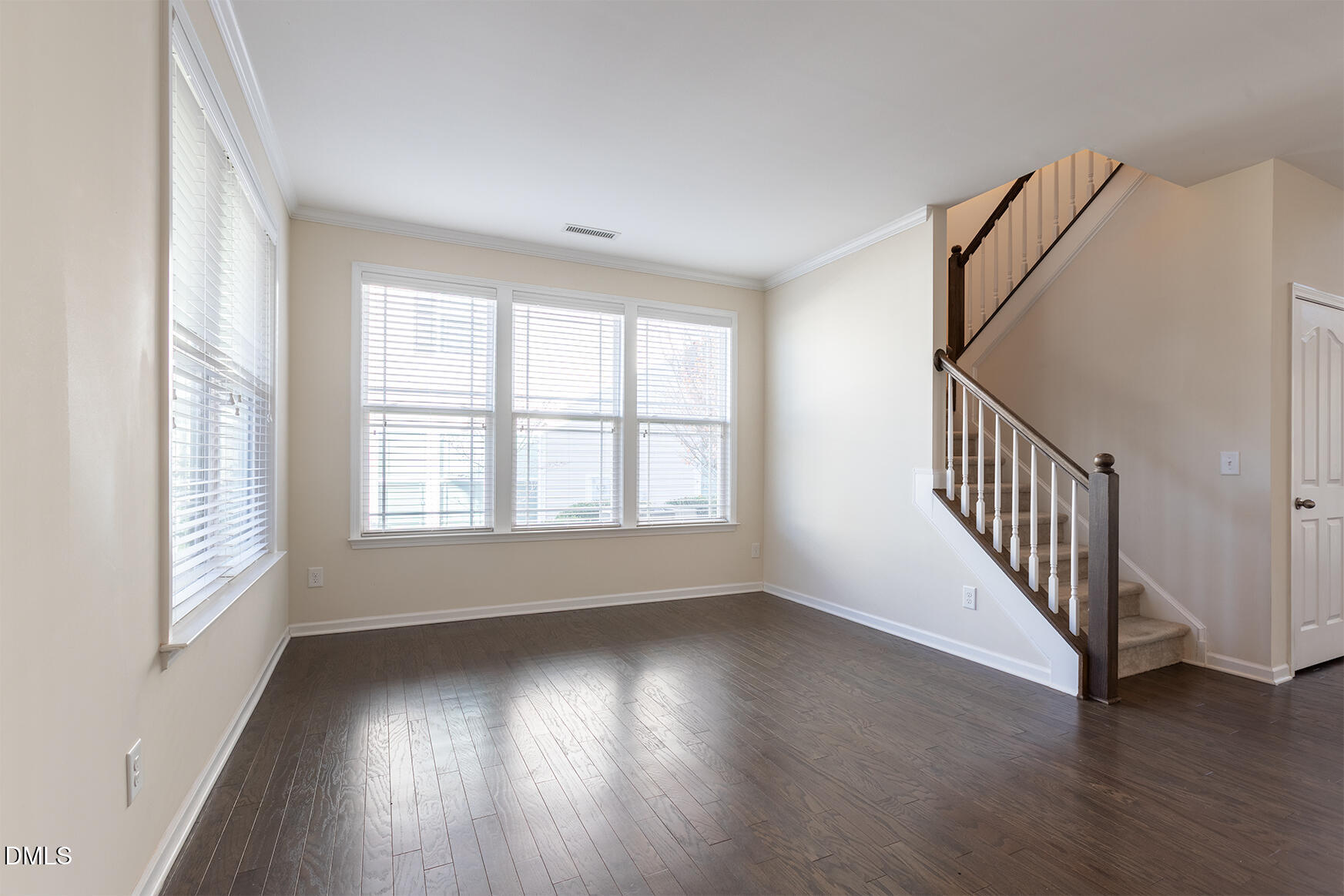 209 Mayfield Drive Apex, NC 27539 - Photo 6 of 48 a view of an empty room with wooden floor and a window