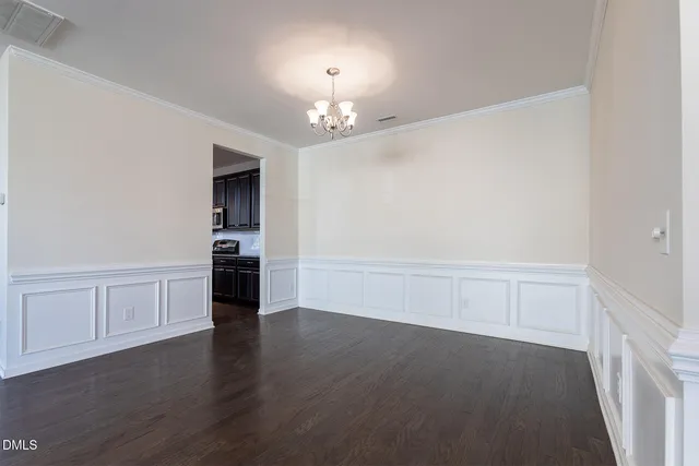 a kitchen with stainless steel appliances granite countertop a refrigerator a sink dishwasher a kitchen island a stove and a wooden floors