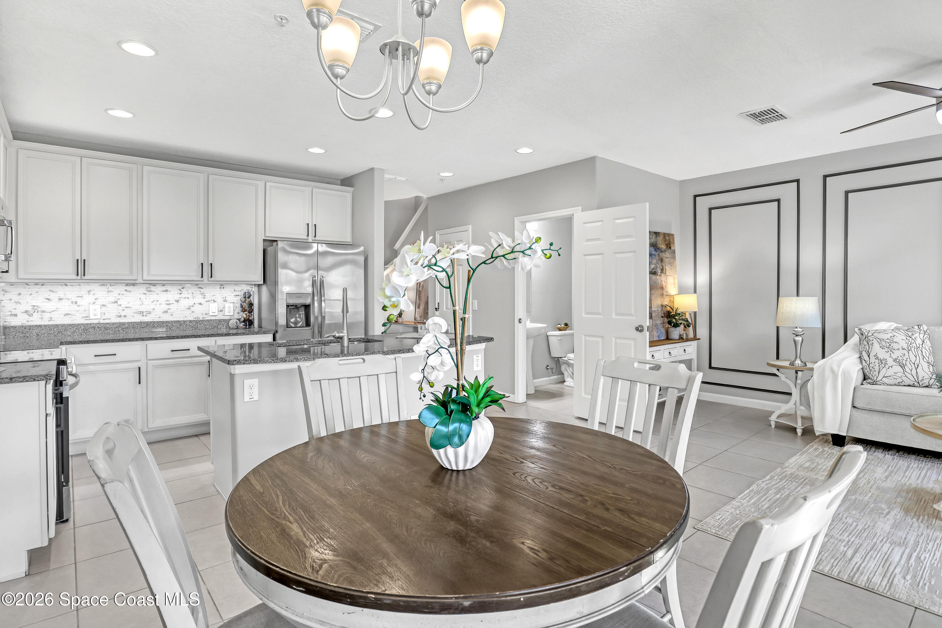 1420 Lara Circle, Unit 102 Rockledge, FL 32955 - Photo 11 of 38 a view of a dining room with furniture a kitchen and chandelier
