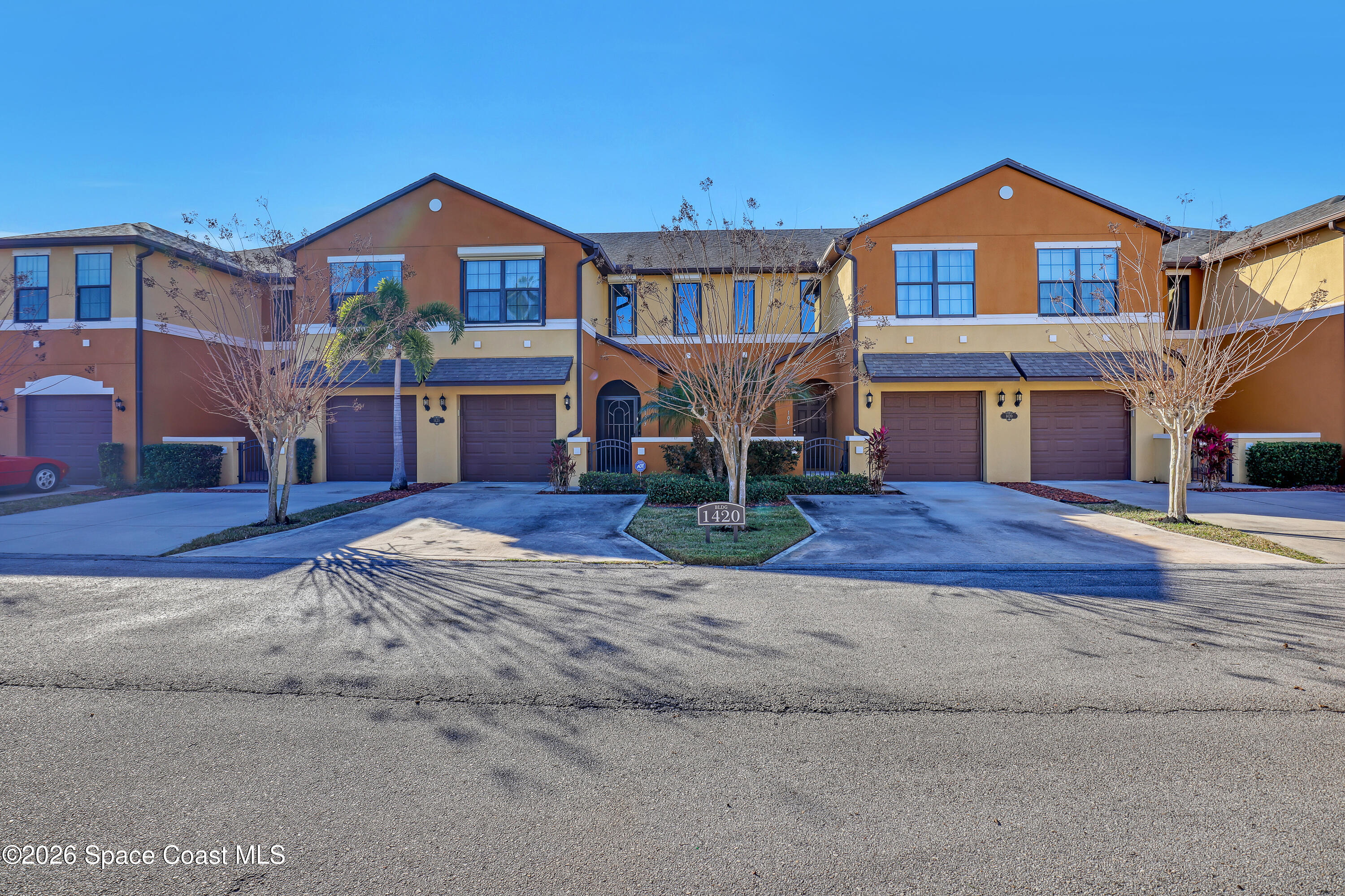 1420 Lara Circle, Unit 102 Rockledge, FL 32955 - Photo 2 of 38 a front view of a house with a yard