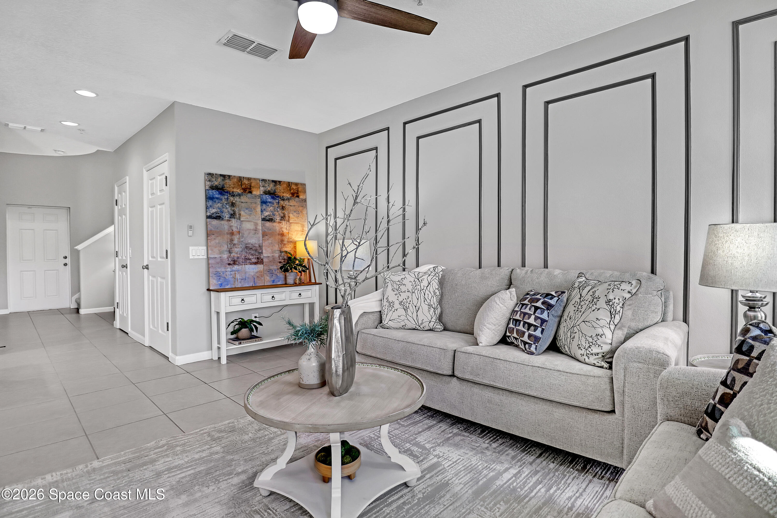 1420 Lara Circle, Unit 102 Rockledge, FL 32955 - Photo 6 of 38 a living room with furniture and a chandelier
