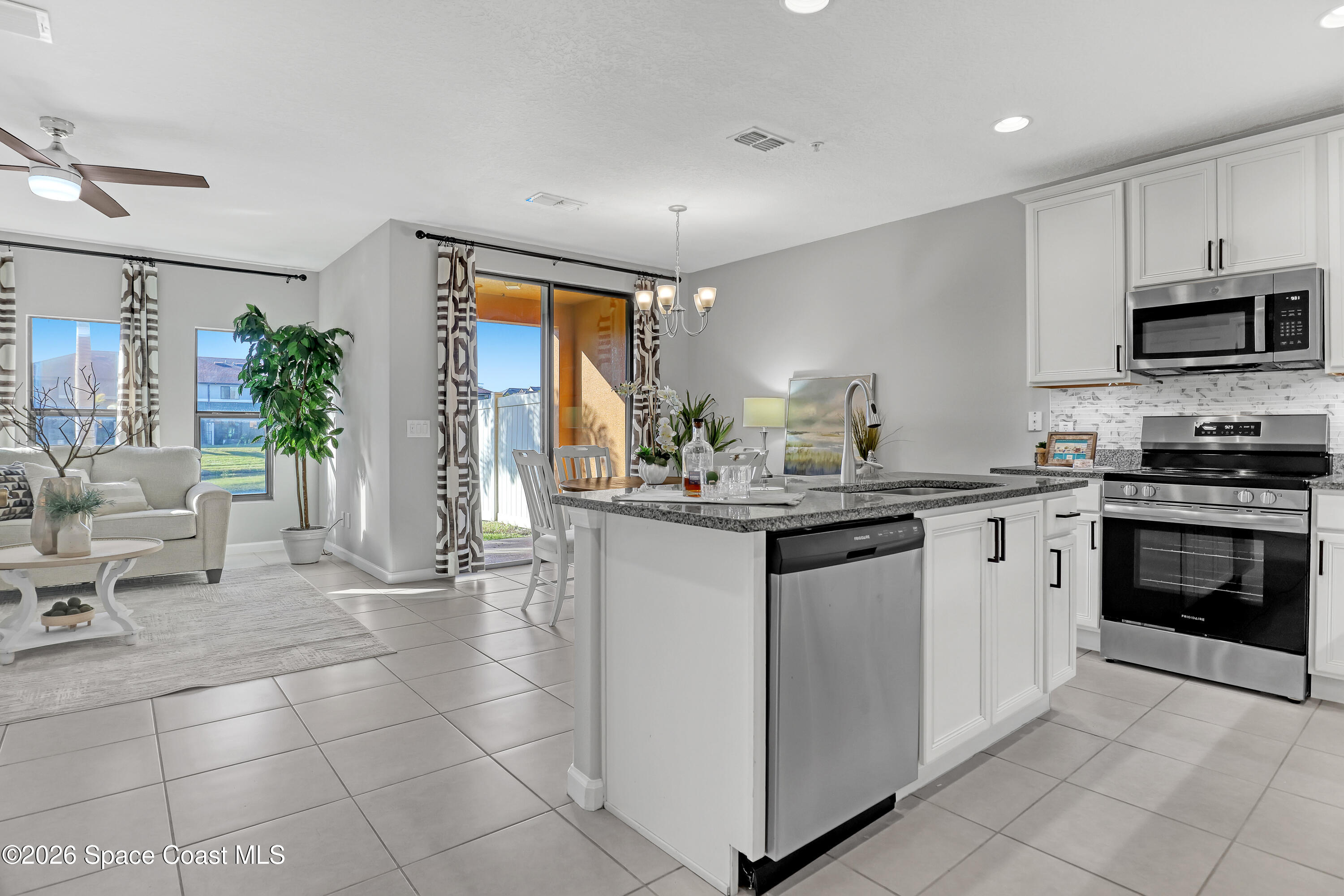 1420 Lara Circle, Unit 102 Rockledge, FL 32955 - Photo 8 of 38 a kitchen with a sink and white cabinets