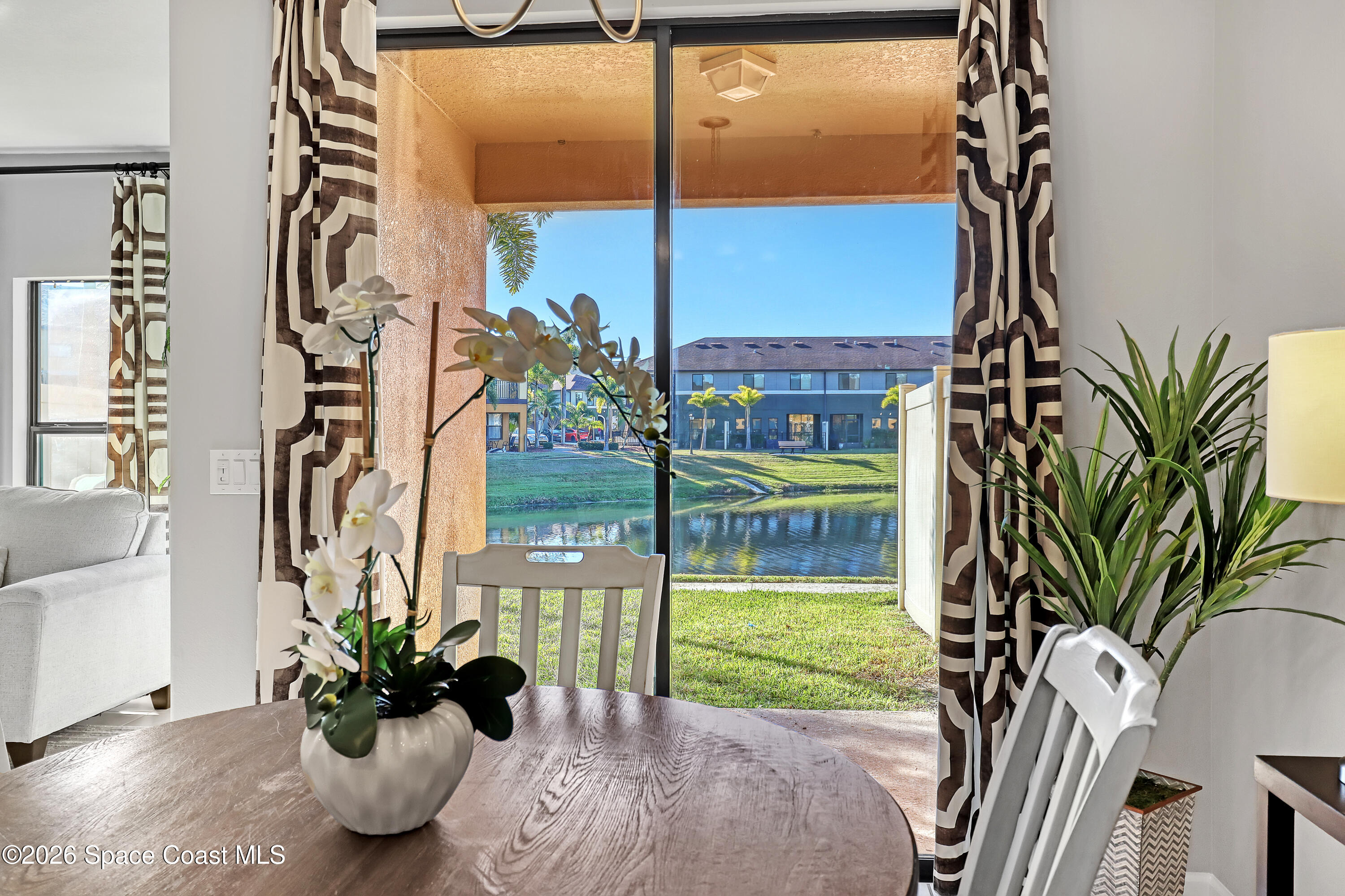 1420 Lara Circle, Unit 102 Rockledge, FL 32955 - Photo 10 of 38 a vase of flowers sitting next to a window