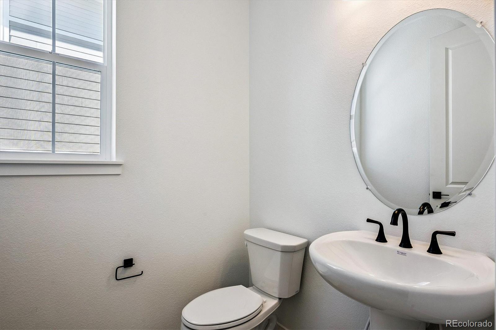 17543 East Virginia Avenue Aurora, CO 80017 - Photo 13 of 26 a bathroom with a sink mirror and toilet
