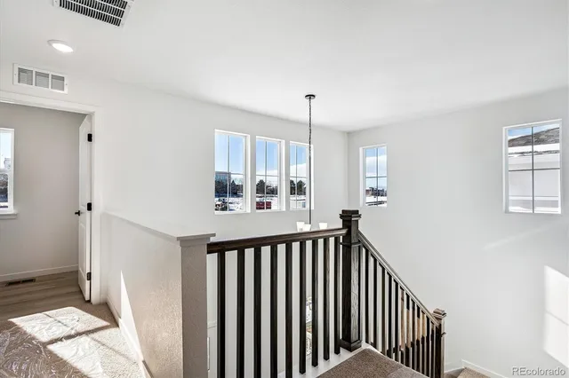 a view of a hallway to a livingroom and a window