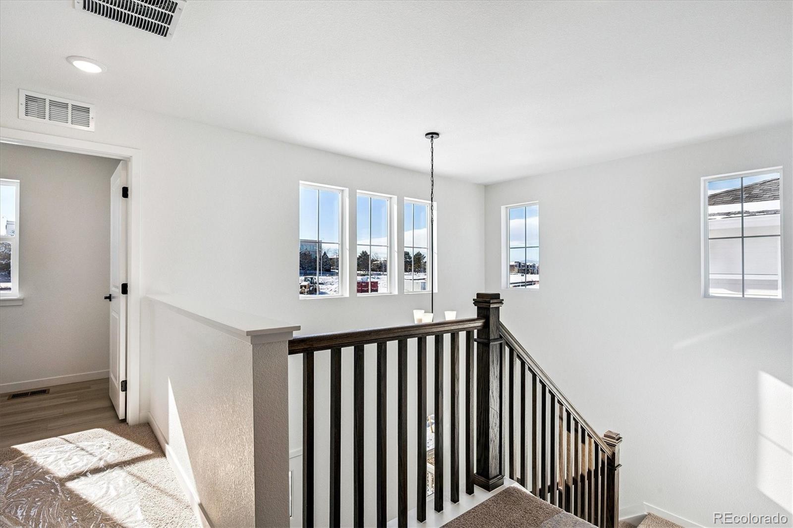 17543 East Virginia Avenue Aurora, CO 80017 - Photo 14 of 26 a view of a hallway to a livingroom and a window
