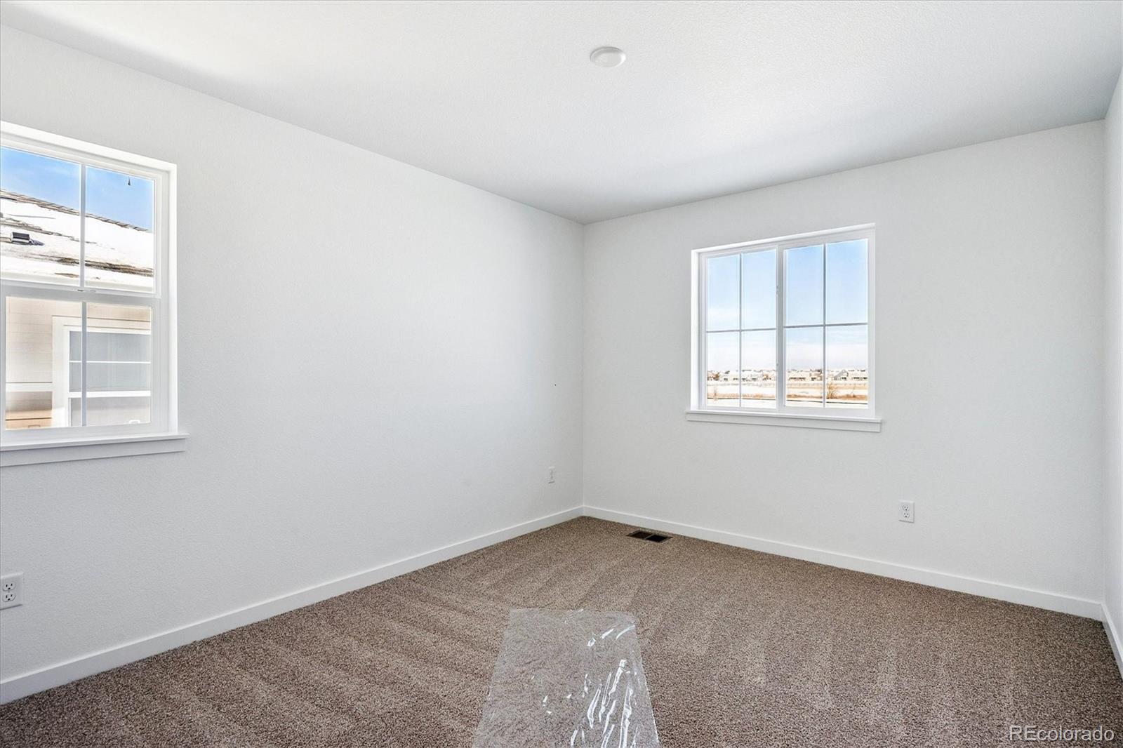 17543 East Virginia Avenue Aurora, CO 80017 - Photo 18 of 26 an empty room with windows
