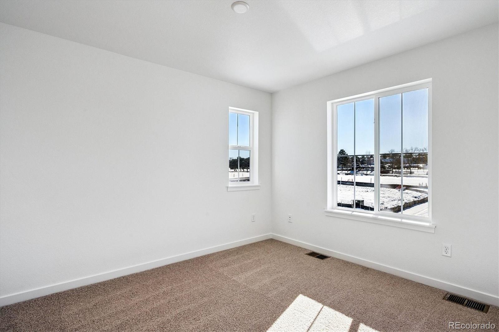 17543 East Virginia Avenue Aurora, CO 80017 - Photo 21 of 26 an empty room with windows
