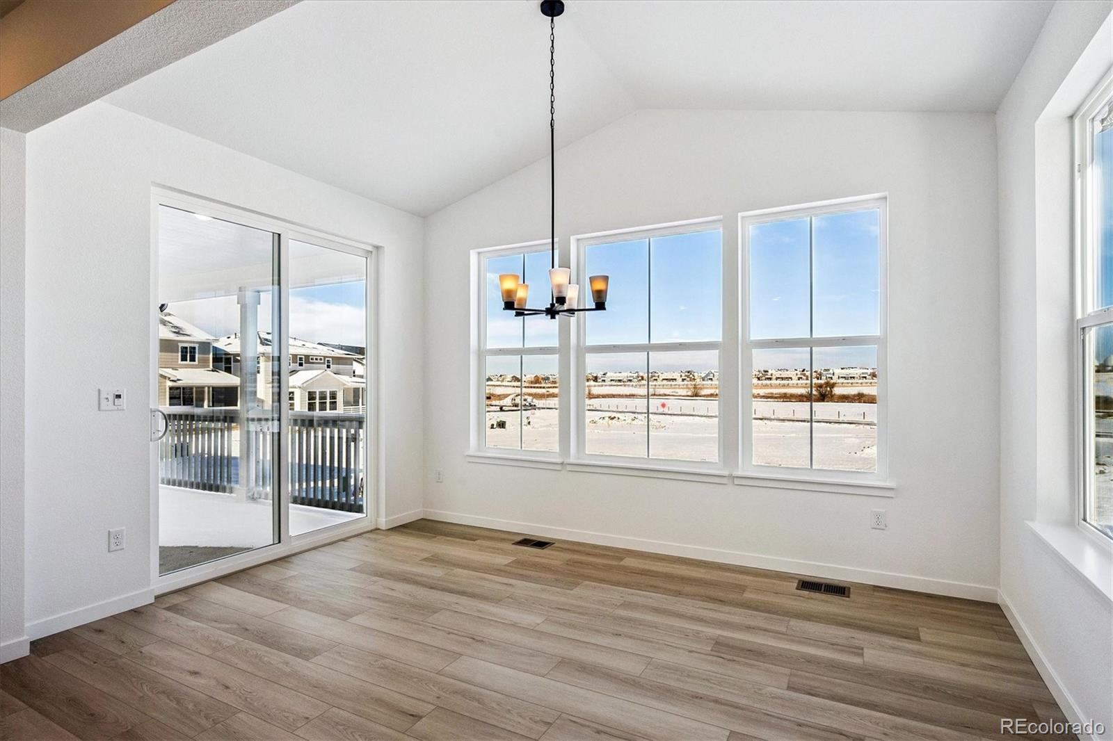 17543 East Virginia Avenue Aurora, CO 80017 - Photo 10 of 26 a view of an empty room with wooden floor and a window