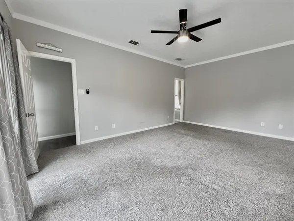 a view of a livingroom with a ceiling fan and window