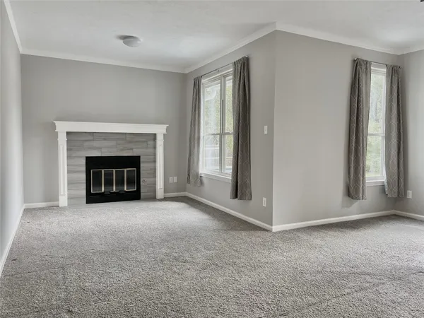 an empty room with chandelier fan