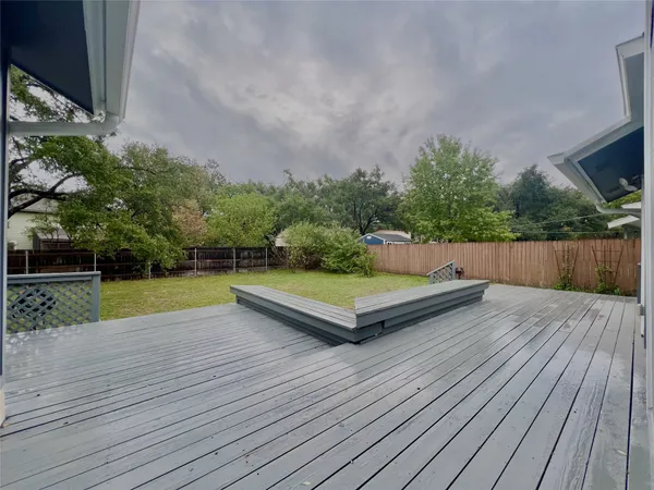 a view of a wooden deck with a yard