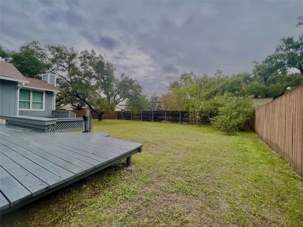 a view of a backyard with a wooden deck