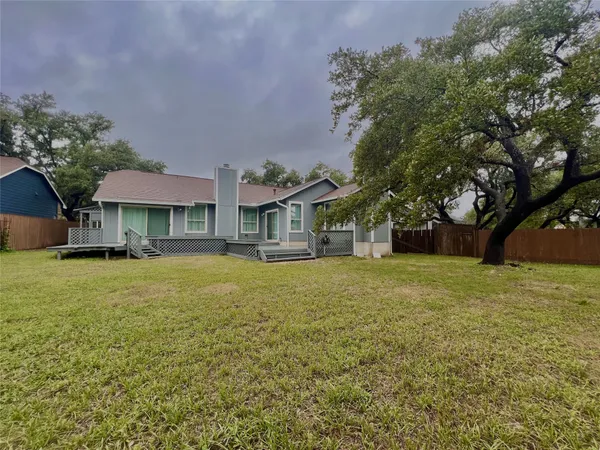 a front view of house with yard and trees