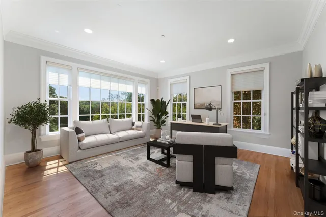 a living room with fireplace furniture and a large window