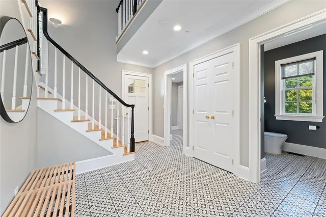 a view of a hallway with windows and stairs
