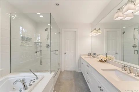 a bathroom with a double vanity sink mirror double and shower