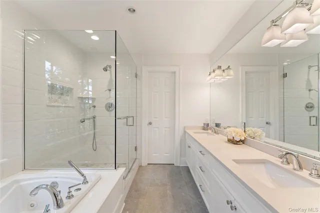 a bathroom with a double vanity sink mirror double and shower