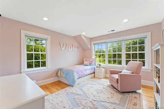 a bedroom with furniture and a large window