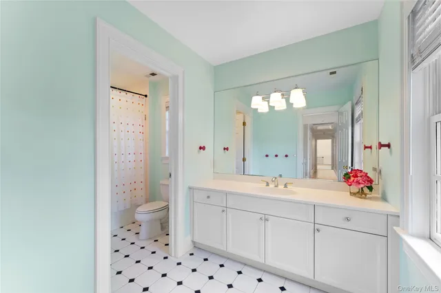 a spacious bathroom with a sink mirror and shower