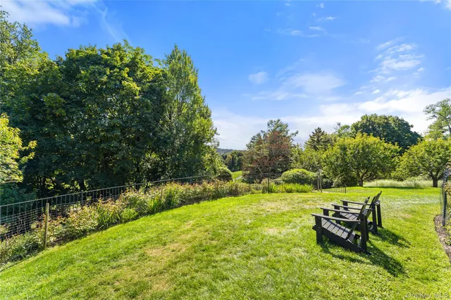 a view of a lake with a yard and a bench