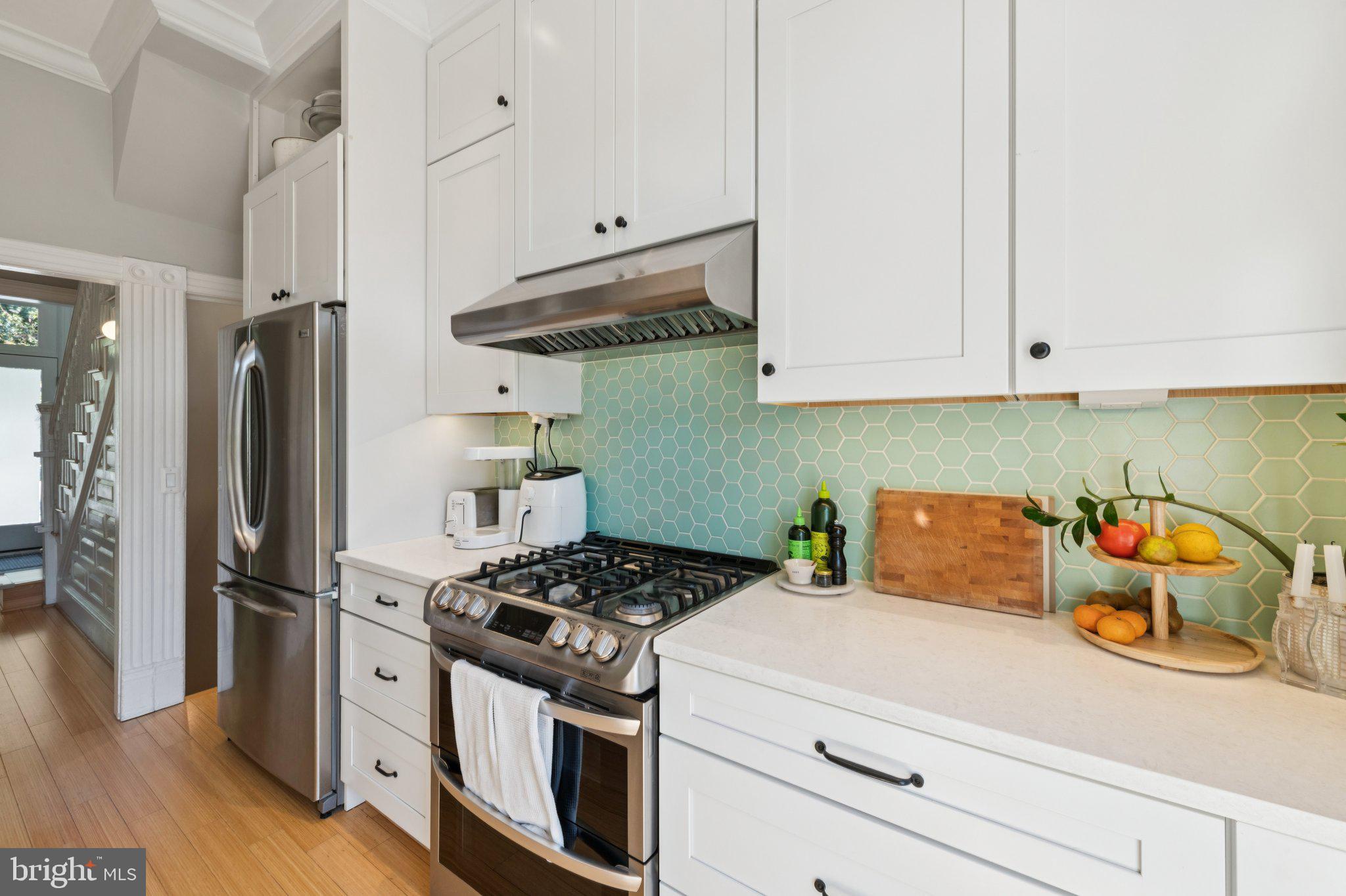 21 V Street Northeast Washington, DC 20002 - Photo 12 of 32 a kitchen with stainless steel appliances granite countertop a refrigerator and a stove
