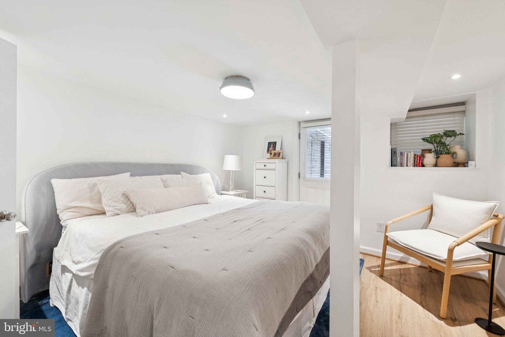 21 V Street Northeast Washington, DC 20002 - Photo 16 of 32 a bedroom with a bed and a chair