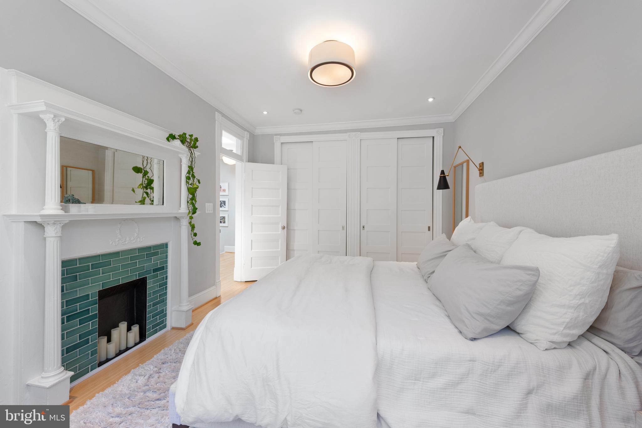 21 V Street Northeast Washington, DC 20002 - Photo 21 of 32 a bedroom with a bed and a fireplace