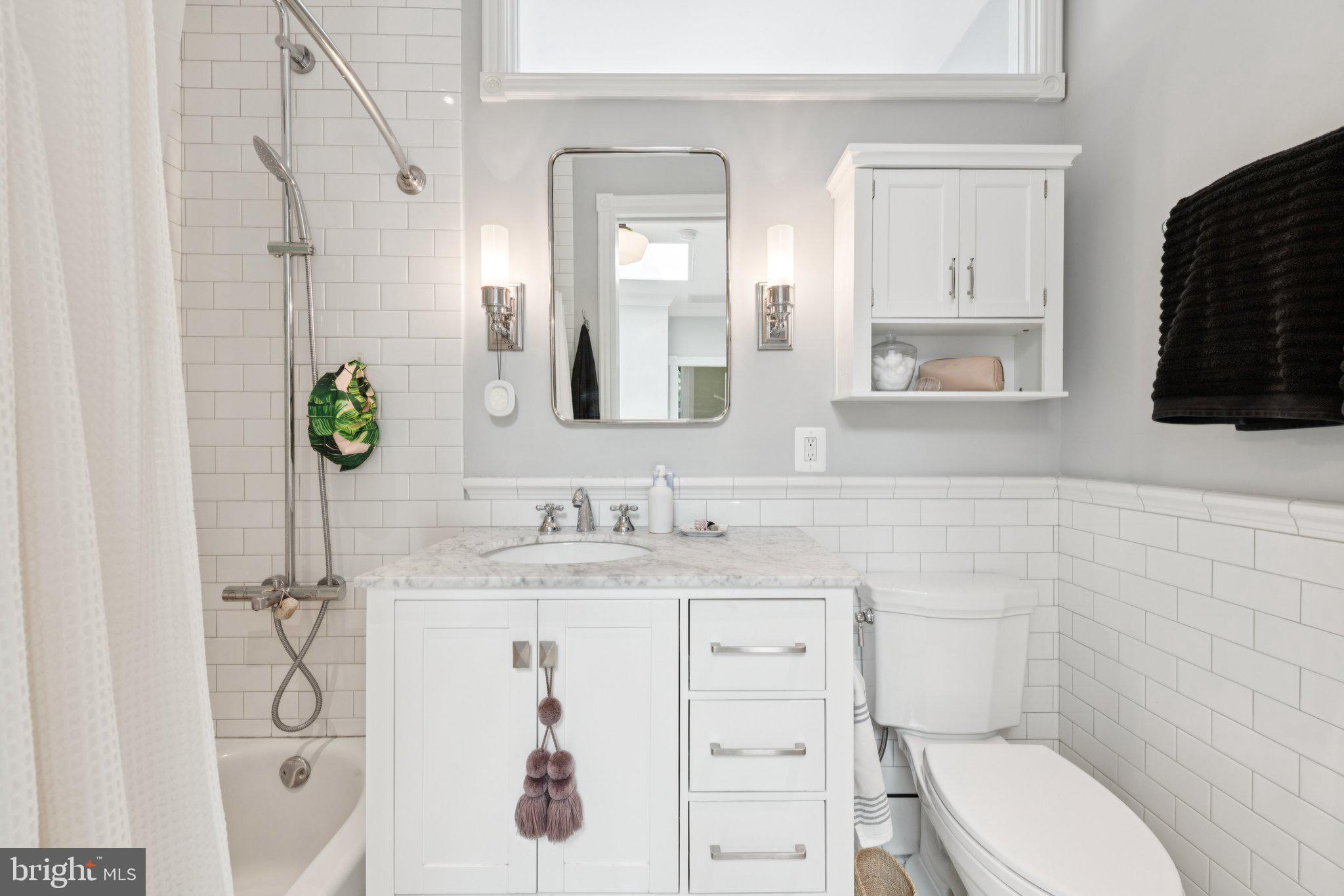 21 V Street Northeast Washington, DC 20002 - Photo 22 of 32 a bathroom with a granite countertop sink mirror and toilet