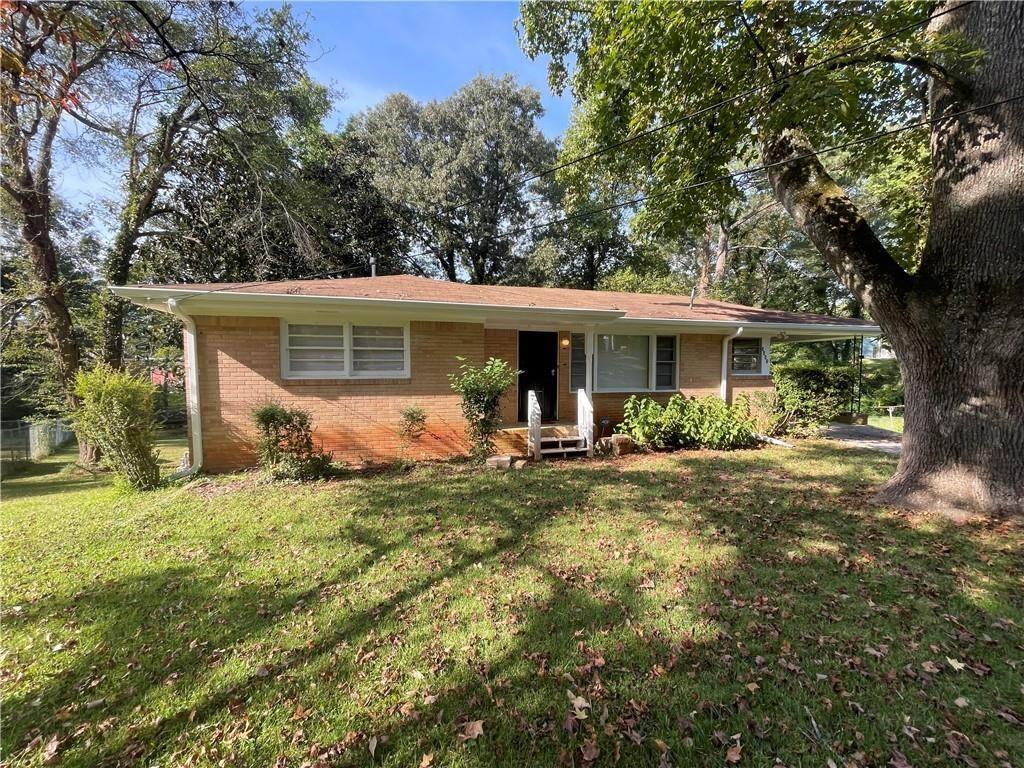 a view of a house with backyard porch and sitting area