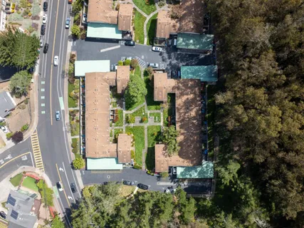 an aerial view of a house with a yard