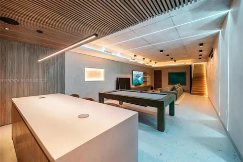 a room with pool table and windows