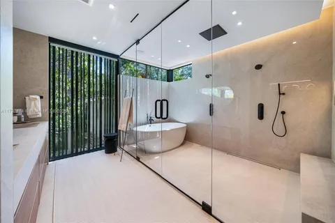 a bathroom with a shower and a sink