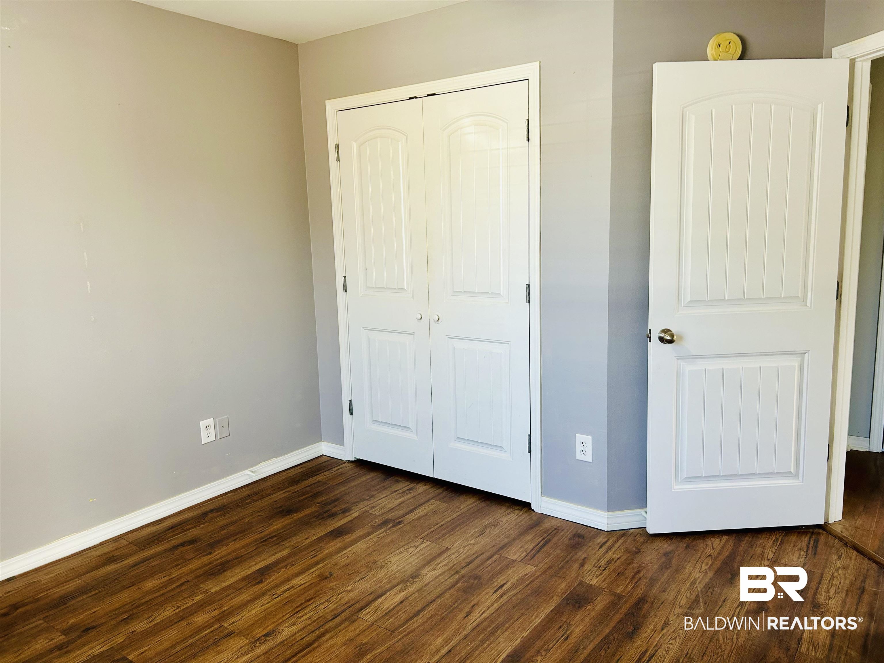 919 Parliament Court Mobile, AL 36695 - Photo 13 of 19 Unfurnished bedroom featuring dark hardwood / wood-style floors and a closet