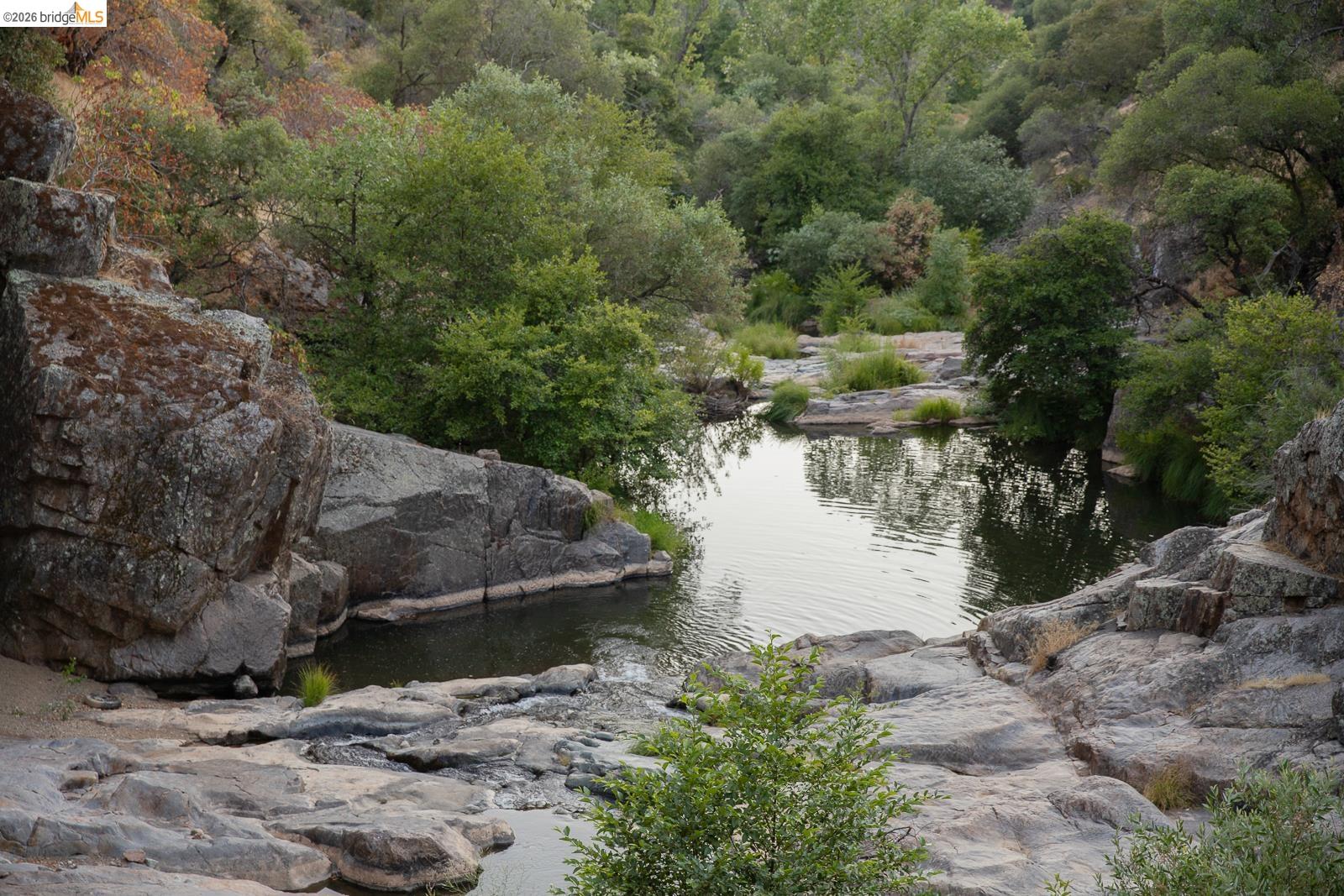 18399 Lime Kiln Road Sonora, CA 95370 - Photo 1 of 36 Natural rock formations surrounding a tranquil body of water