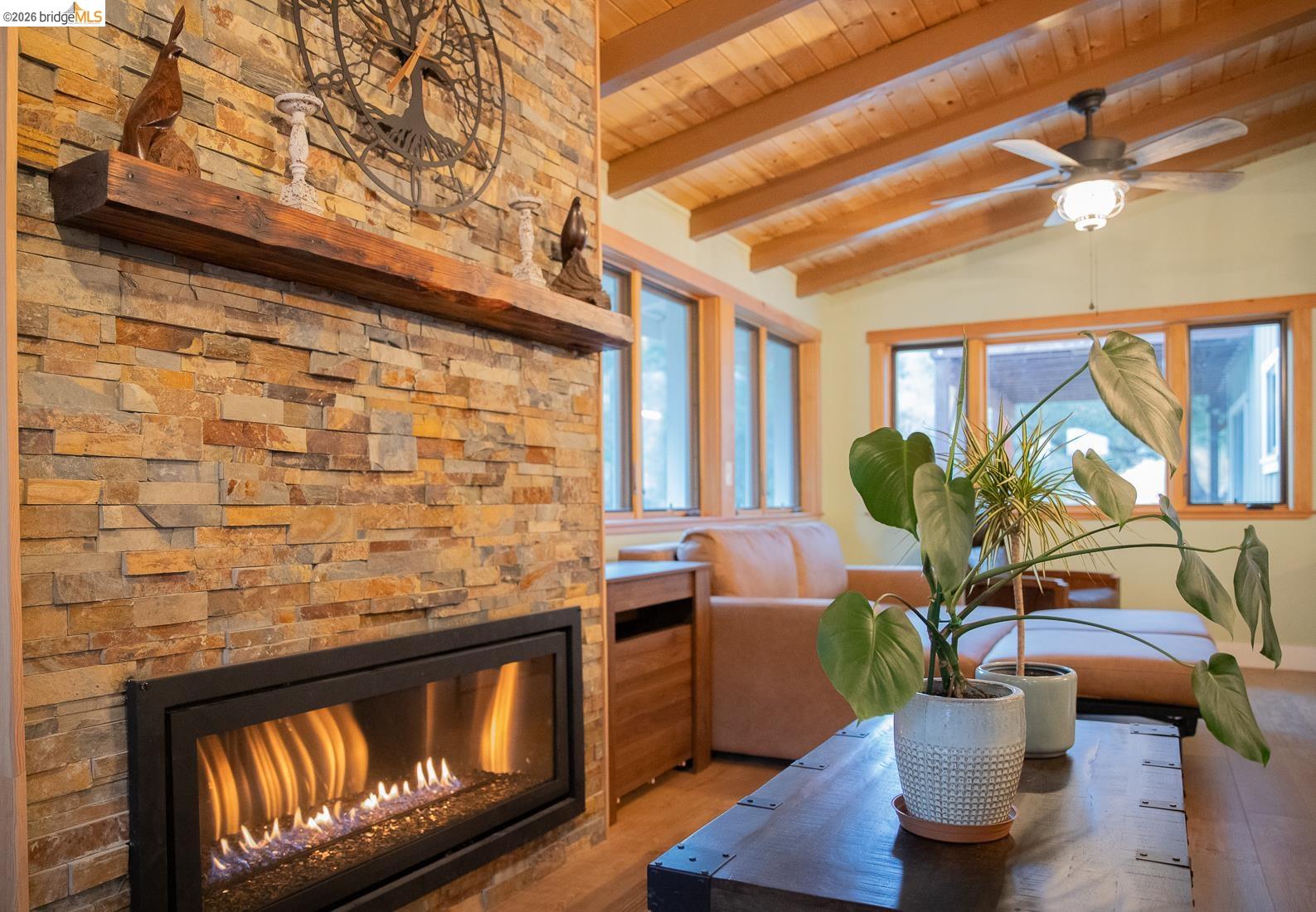 18399 Lime Kiln Road Sonora, CA 95370 - Photo 11 of 36 Stacked stone fireplace with a rustic wood mantel