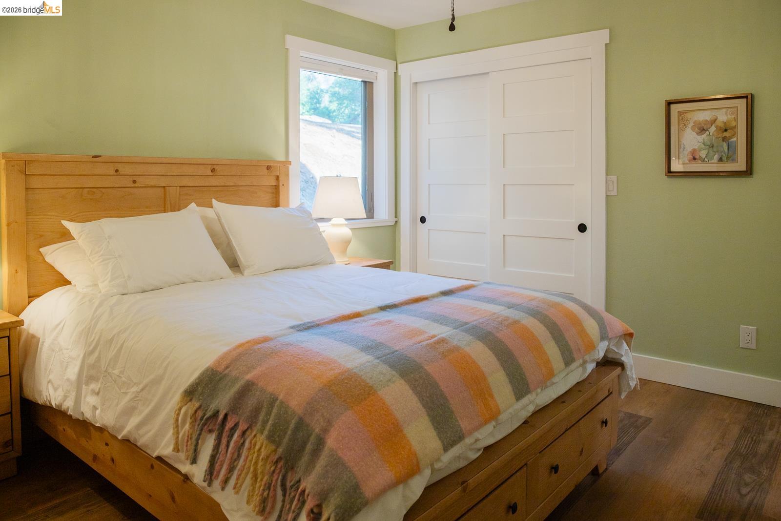 18399 Lime Kiln Road Sonora, CA 95370 - Photo 18 of 36 Bedroom featuring wood-finish flooring and a window with white trim