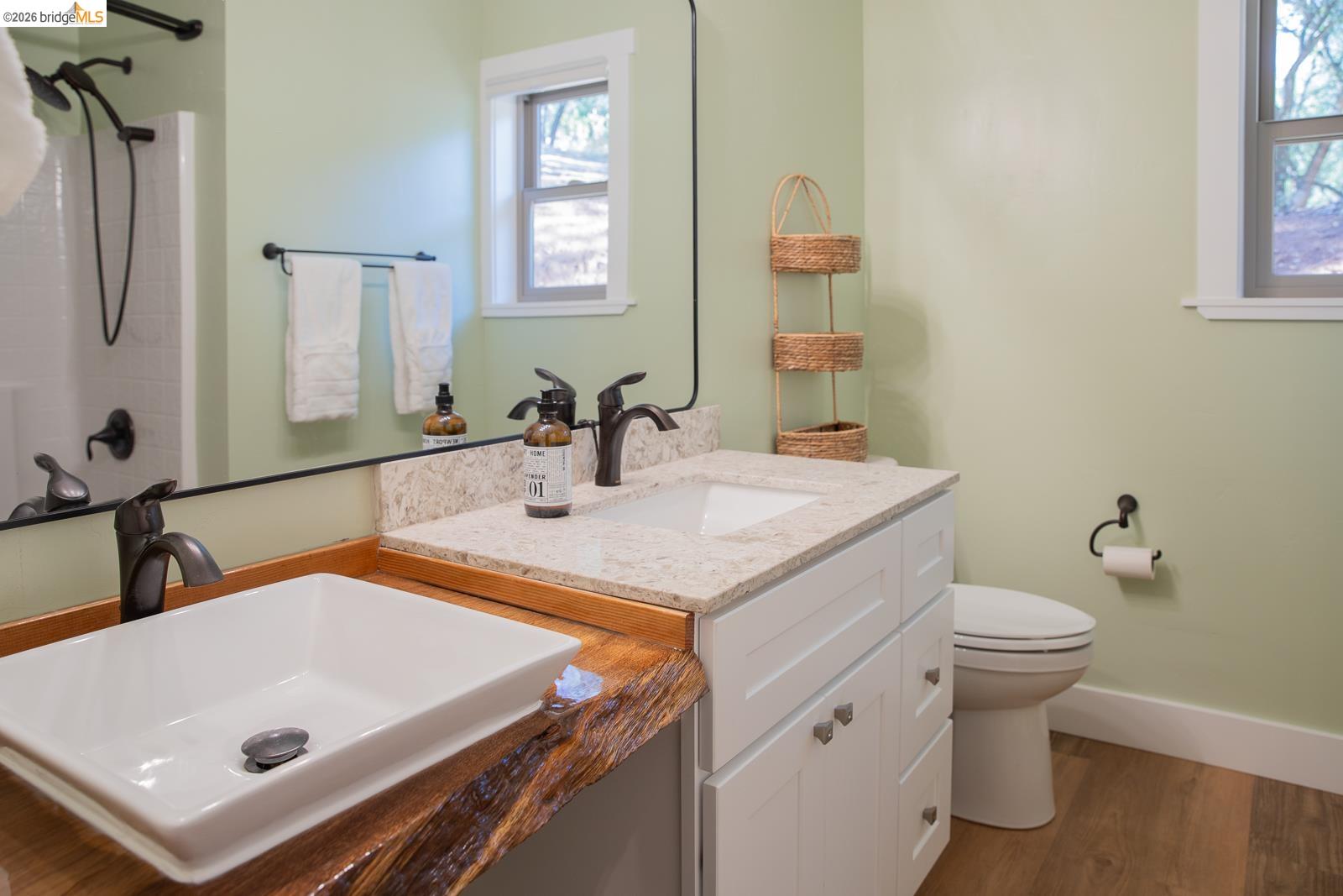 18399 Lime Kiln Road Sonora, CA 95370 - Photo 25 of 36 Bathroom featuring a live-edge wood countertop, a rectangular vessel sink with dark bronze faucet, and a second vanity with a light-toned countertop and integrated sink