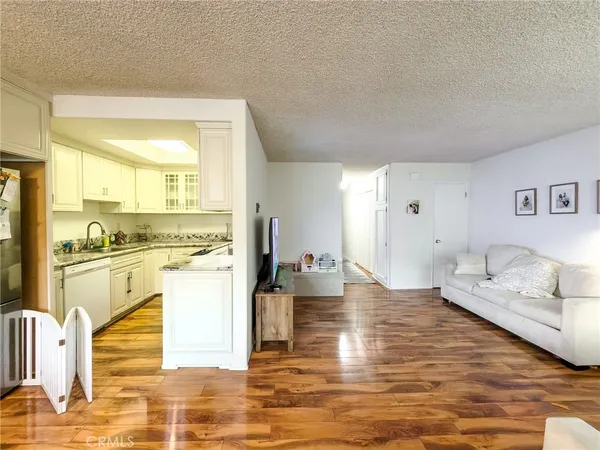 a view of a kitchen with stainless steel appliances granite countertop a stove and a sink