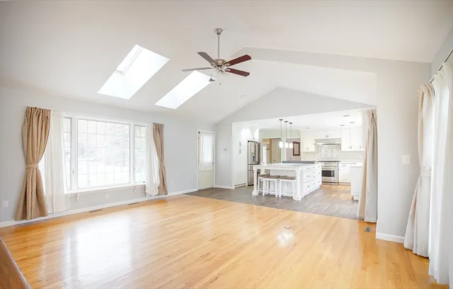 a kitchen with a table chairs refrigerator and cabinets