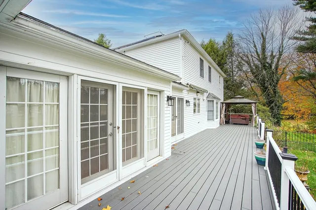 a view of a house with a big yard plants and large trees