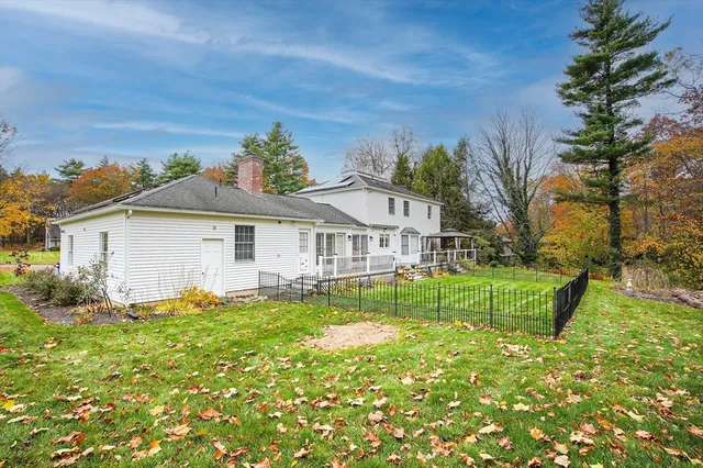 a front view of a house with a garden and plants