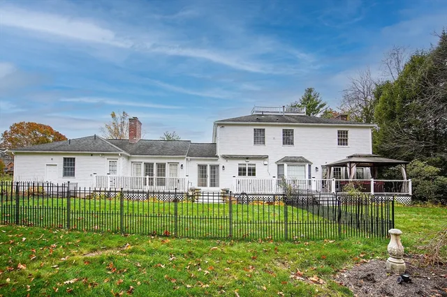 a house view with swimming pool in front of it