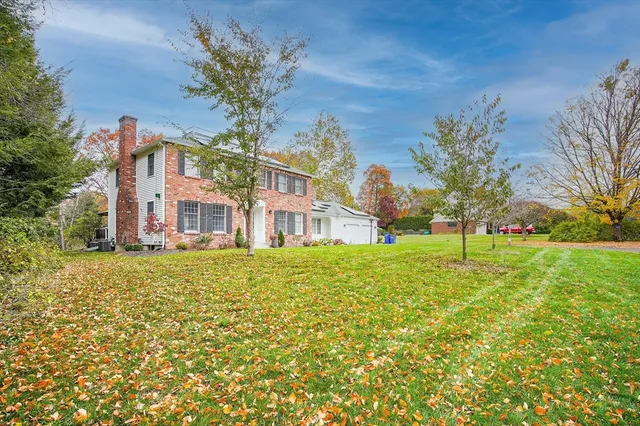 a house with green field in front of it