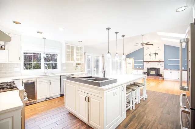 a kitchen with stainless steel appliances granite countertop a stove and a wooden floors