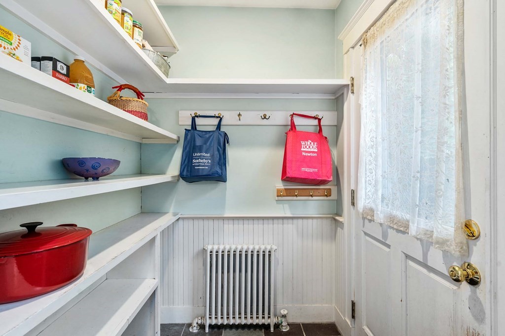 47 Stearns Street Newton, MA 02459 - Photo 21 of 32 a room with lots of books and white walls