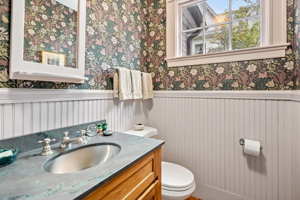 47 Stearns Street Newton, MA 02459 - Photo 22 of 32 a bathroom with a granite countertop sink and a large mirror