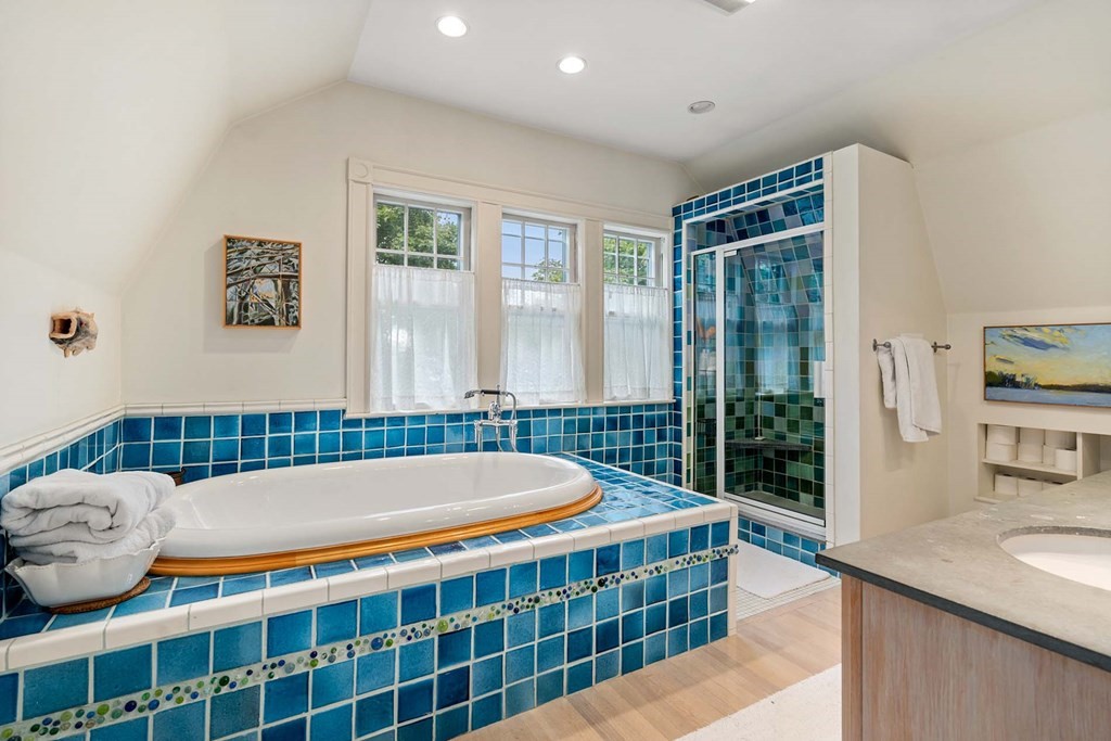 47 Stearns Street Newton, MA 02459 - Photo 24 of 32 a bathroom with a tub sink and glass door
